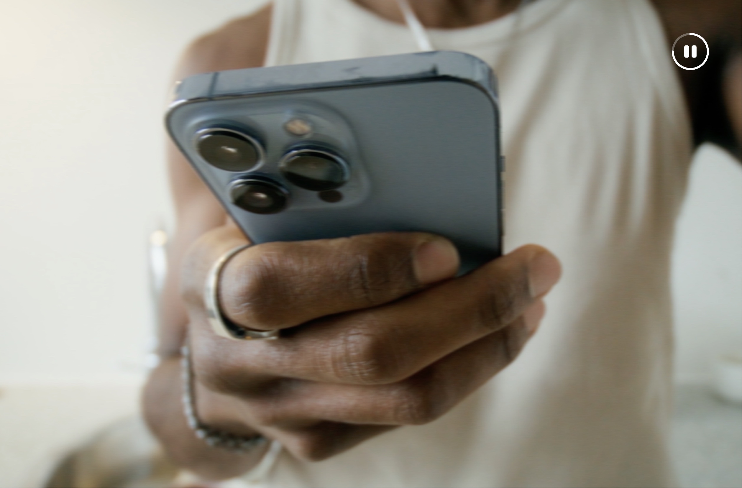 Campaign video still: a person holding a phone